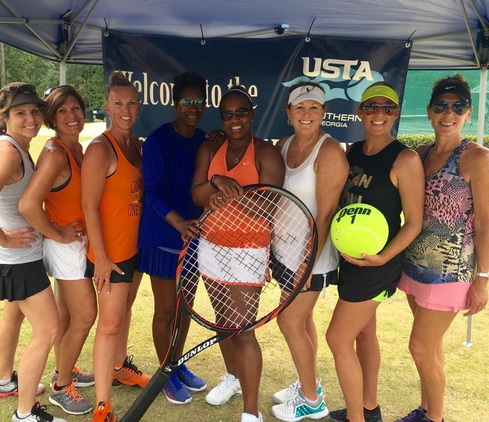 SCTA ladies with a big tennis ball and racket